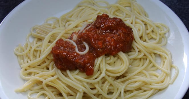 Spaghetti pasta on a plate with red sauce