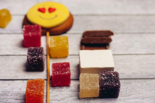 gingerbread in the form of a smiley on a stick marmalade sweets dessert enjoyment wooden background. High quality photo