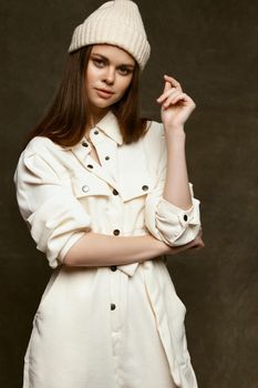 young woman in overalls and in a white hat on a dark background. High quality photo