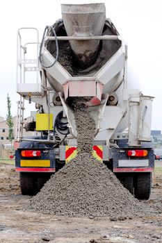 Ready-mix semi-dry concrete delivered on construction site and discharged from the mixing truck