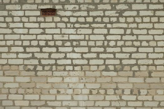 White brick wall. Part of the wall was completed later. Texture.