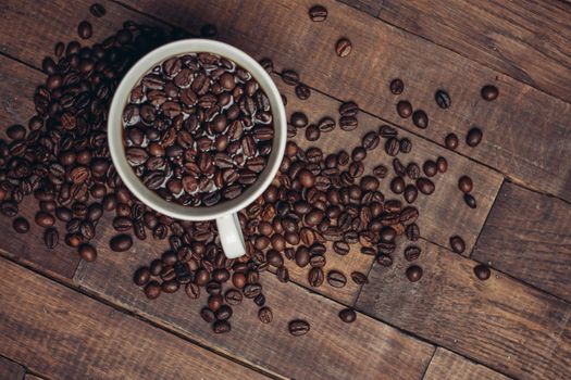 white cup with coffee beans aromatic drink morning. High quality photo