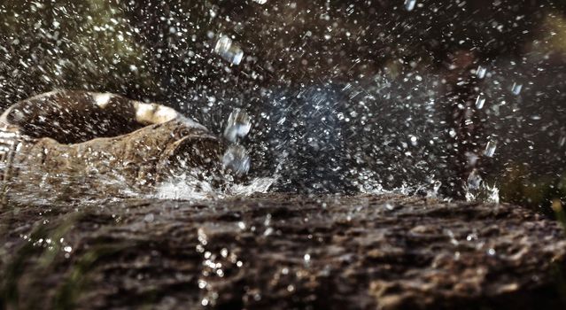 Wet stone and decorative antique urn in the rain. Rain water drop falling to the stone. Water is flowing and splashing around them.
