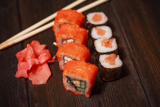 sushi rolls wooden sticks seafood filling delicacy asian food. High quality photo