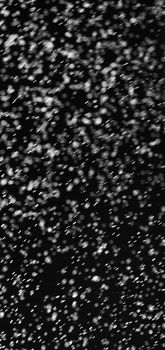 Rain on black. Abstract splashes of water on a black background for screen blending mode and photo retouching.
