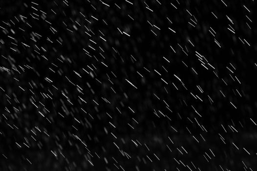 Rain on black. Abstract splashes of water on a black background for screen blending mode and photo retouching.