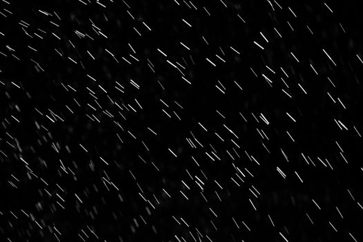 Rain on black. Abstract splashes of water on a black background for screen blending mode and photo retouching.