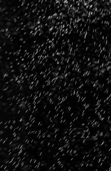 Rain on black. Abstract splashes of water on a black background for screen blending mode and photo retouching.