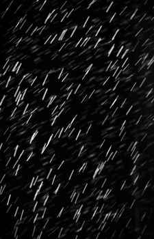 Rain on black. Abstract splashes of water on a black background for screen blending mode and photo retouching.