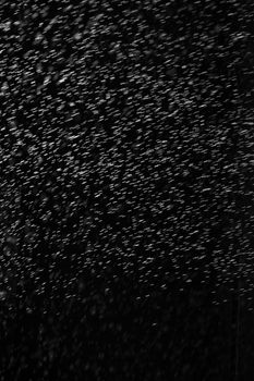 Rain on black. Abstract splashes of water on a black background for screen blending mode and photo retouching.
