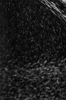 Rain on black. Abstract splashes of water on a black background for screen blending mode and photo retouching.