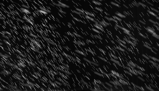 Rain on black. Abstract splashes of water on a black background for screen blending mode and photo retouching.