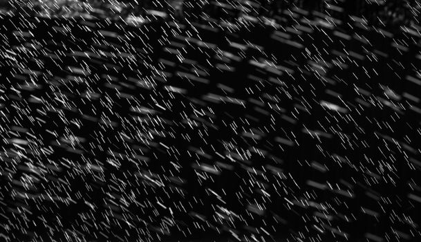 Rain on black. Abstract splashes of water on a black background for screen blending mode and photo retouching.