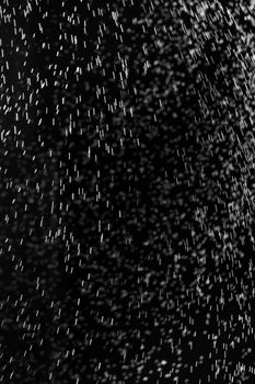 Rain on black. Abstract splashes of water on a black background for screen blending mode and photo retouching.