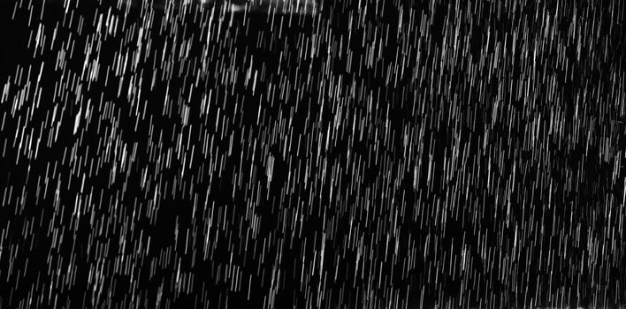 Rain on black. Abstract splashes of water on a black background for screen blending mode and photo retouching.