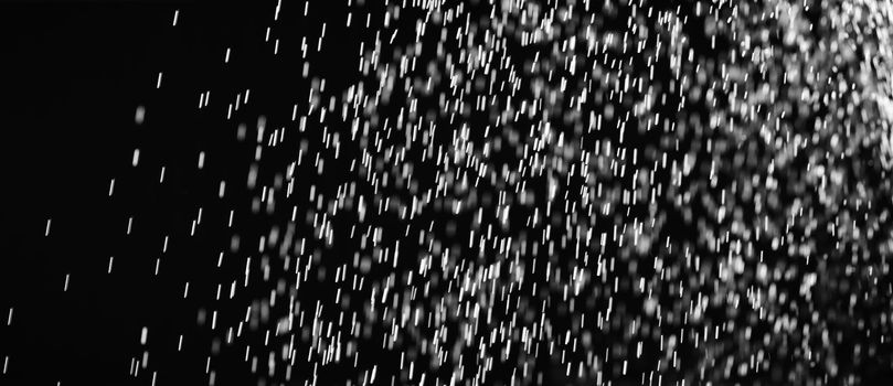 Rain on black. Abstract splashes of water on a black background for screen blending mode and photo retouching.