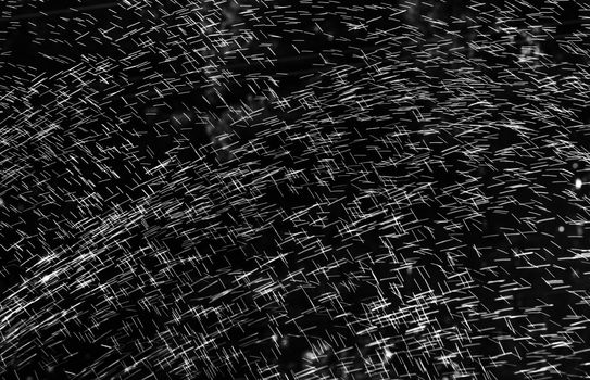 Rain on black. Abstract splashes of water on a black background for screen blending mode and photo retouching.