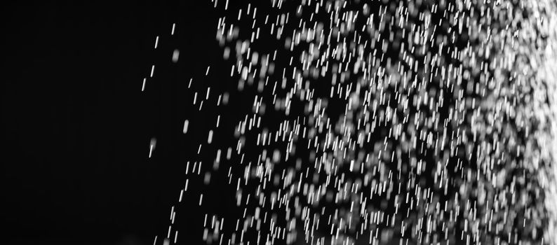 Rain on black. Abstract splashes of water on a black background for screen blending mode and photo retouching.