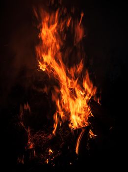 Flames of bonfire at night. Fire flames on a black background