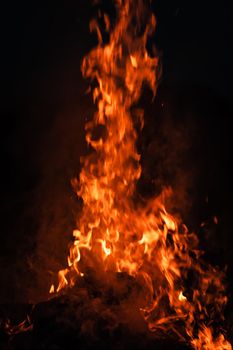 Flames of bonfire at night. Fire flames on a black background