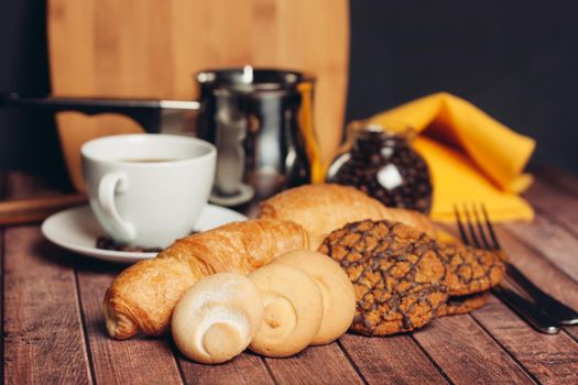 sweets for tea croissants cookies on a wooden table snack. High quality photo