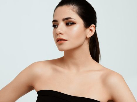 woman approximate casually looks to the side on a light background and shadows on eyelids model. High quality photo