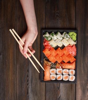 set of sushi and rolls on a wooden table asian food ginger wasabi japanese cuisine. High quality photo