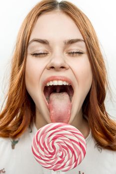 pretty woman licks round lollipop delight dessert sweets. High quality photo