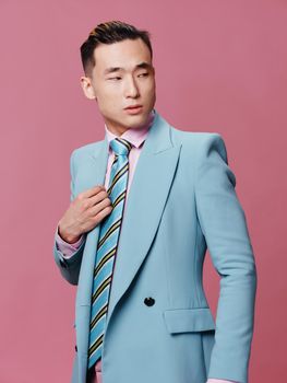 Male Asian appearance suit official elegant style pink background. High quality photo