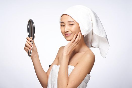 pretty woman looking in the mirror clean skin after shower. High quality photo