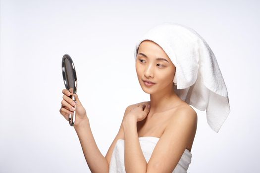 pretty woman looking in the mirror clean skin after shower. High quality photo