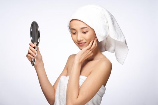 pretty woman looking in the mirror clean skin after shower. High quality photo
