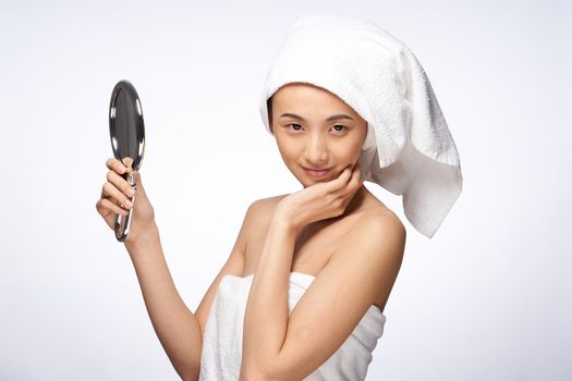 pretty woman looking in the mirror clean skin after shower. High quality photo