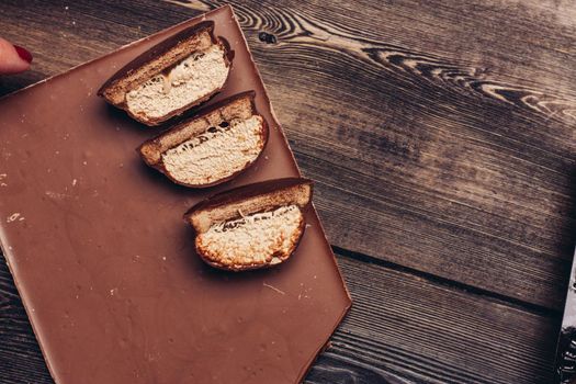 chocolate and pastries on wooden table background image texture delicacy dessert. High quality photo