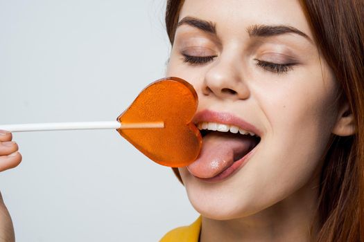 cute red-haired woman with lollipop in her mouth glamor closeup. High quality photo