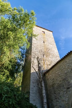 Autumn landscape with multicolored trees and city wall with tower in Berching, Bavaria on a sunny day