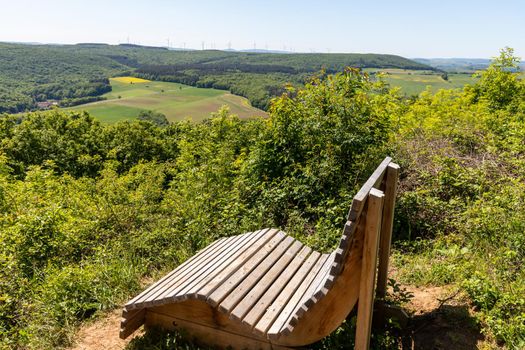 Scenic view from the Lemberg at landscape with  wooden relaxing bench in the foreground