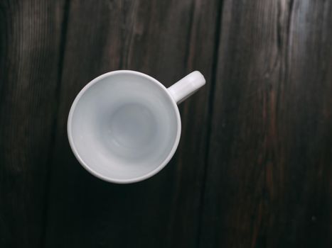 white mug on the table indoors stand texture top view. High quality photo