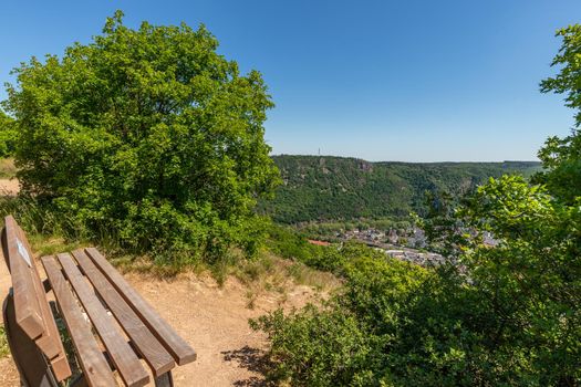 High angle view from the Rotenfels of Bad Muenster am Stein Ebernburg with wooden bench in the foreground