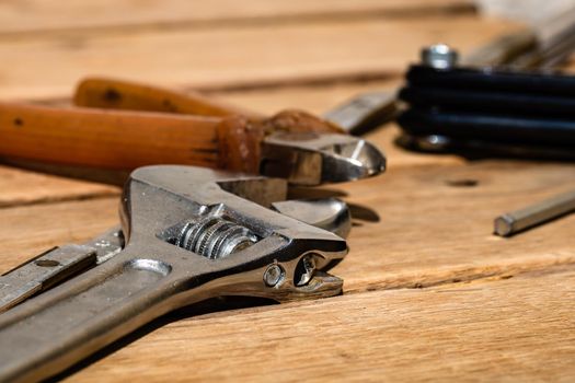 Tools for repair and building. Hummer, adjustable spanner, ruler. Instruments on rustic wooden table with copy space