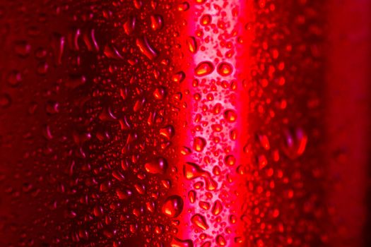 Water droplets on red metallic can