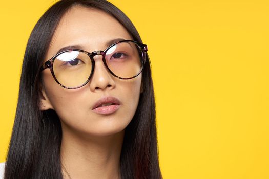 Business woman asian appearance glasses elegant style yellow background. High quality photo