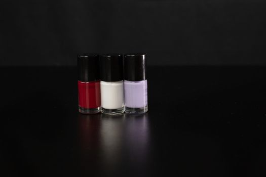 Nail polish bottles isolated on black backgraound.