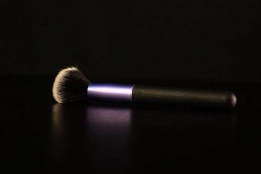 Cosmetic concept, make up brush isolated on black background.