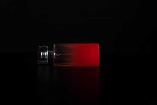 Elegant perfume bottle isolated on black background with copy space.