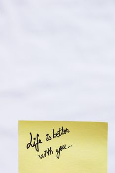 Life is better with you handwriting text close up isolated on yellow paper with copy space.