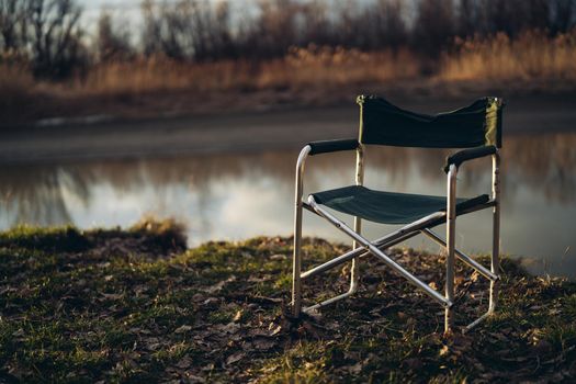 folding chair lakeside travel landscape leisure tourism. High quality photo