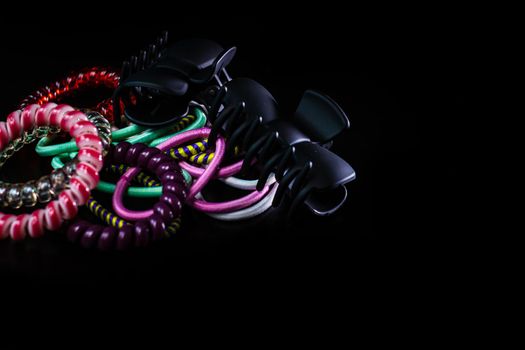 Hair accessories, colorful hair scrunchies isolated on black background.
