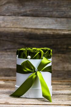 Green roses in a round luxury present box. Bouquet of flowers in a paper box isolated.