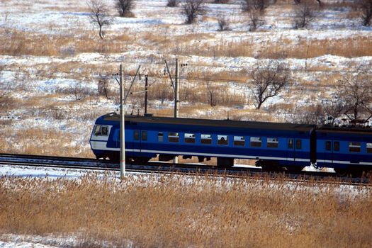 Passenger train or train goes by rail. Passenger transport, travel and logistics on the railway.